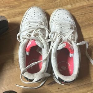 Air force 1’s. Pink with black swoosh. Nike.